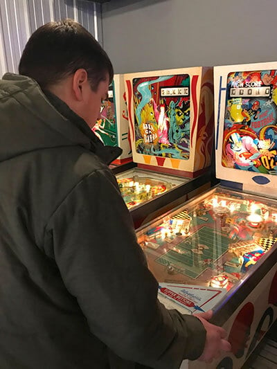 Sean McParland playing a pinball machine